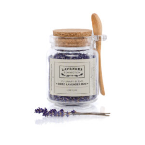 Dried culinary lavender buds in glass container with wooden spoon, edible Royal Velvet lavender from Sequim Washington
